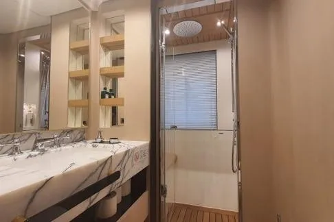  Yacht Photos Pics Luxurious bathroom in 2022 Azimut Grande 32 Metri yacht with marble sink and modern shower.