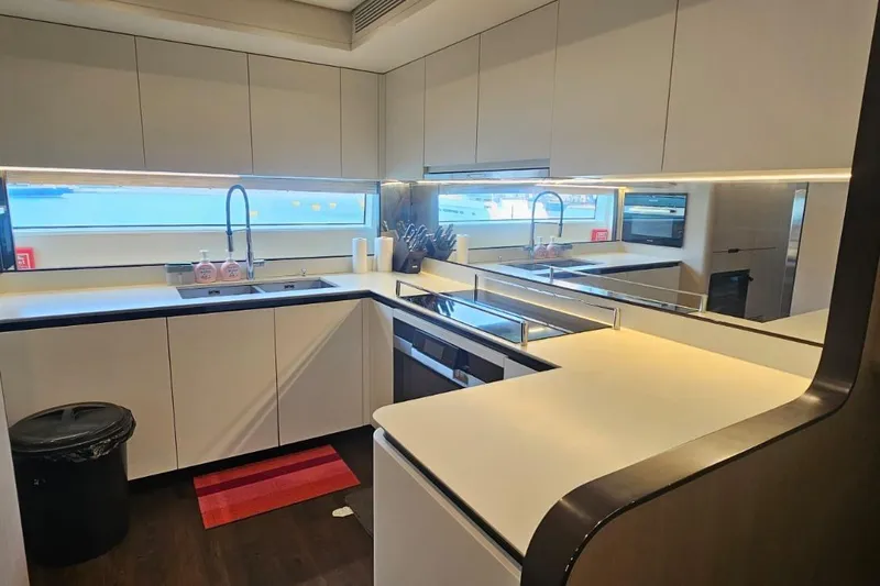  Yacht Photos Pics Modern kitchen interior on 2022 Azimut Grande 32 Metri yacht, featuring sleek countertops and appliances.