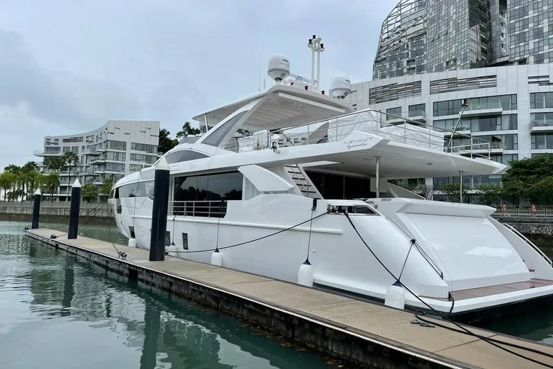  Yacht Photos Pics Luxury Azimut Grande 32 Metri yacht docked, 2022 model, with modern architecture backdrop.