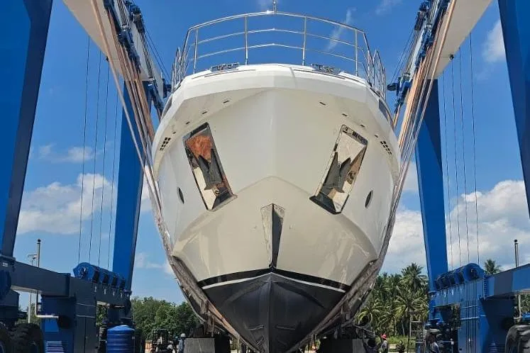  Yacht Photos Pics Azimut Grande 32 Metri yacht, 2022 model, in dry dock under blue sky.