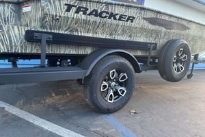 2026 Tracker Grizzly 1650 T Prairie Wings Edition trailer with camouflage design and black wheels.
