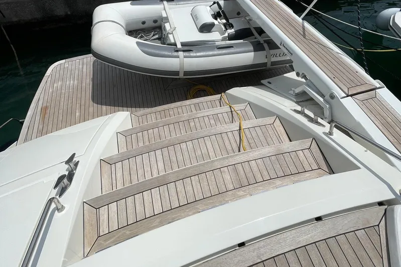  Yacht Photos Pics Cantieri di Sarnico 65 HT 2003 yacht with wooden deck and inflatable boat.