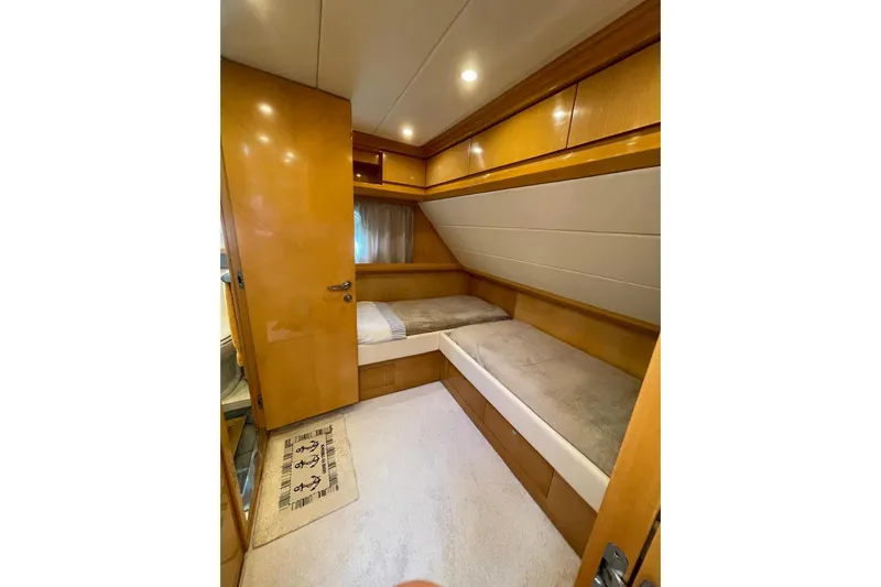  Yacht Photos Pics Interior cabin of 2003 Cantieri di Sarnico 65 HT yacht with twin beds and wooden finish.