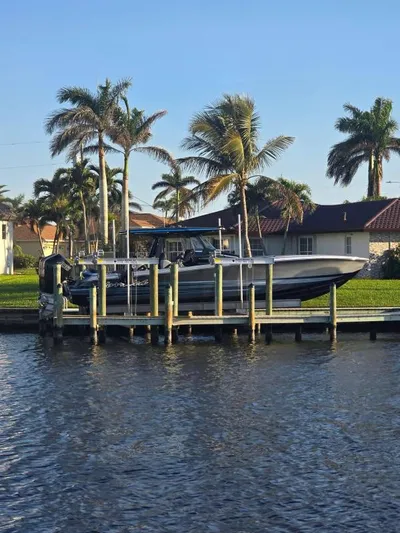  Yacht Photos Pics 2025 Nor-Tech 400SS boat docked by palm trees on a sunny day.