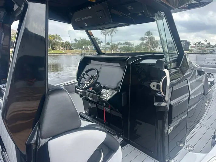  Yacht Photos Pics Interior of 2025 Nor-Tech 400SS boat, featuring sleek black design and modern controls.