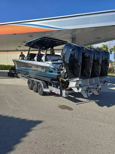  Yacht Photos Pics 2025 Nor-Tech 400SS boat on trailer with four engines, parked under a canopy.