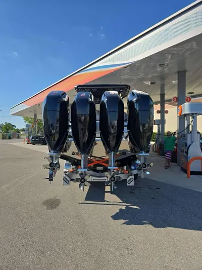  Yacht Photos Pics 2025 Nor-Tech 400SS boat with four powerful outboard engines at a gas station.