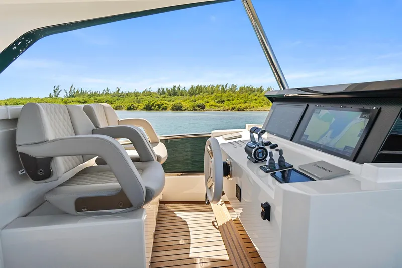 Smile Yacht Photos Pics 2023 Astondoa 66 Flybridge helm with dual seats and navigation screens.