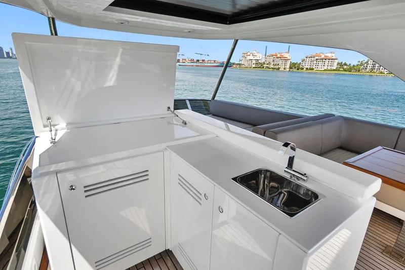 Smile Yacht Photos Pics Astondoa 66 Flybridge 2023 yacht kitchen with sink, overlooking waterfront view.