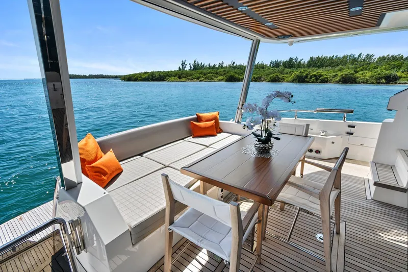 Smile Yacht Photos Pics Luxurious 2023 Astondoa 66 Flybridge yacht with elegant outdoor seating and scenic ocean view.