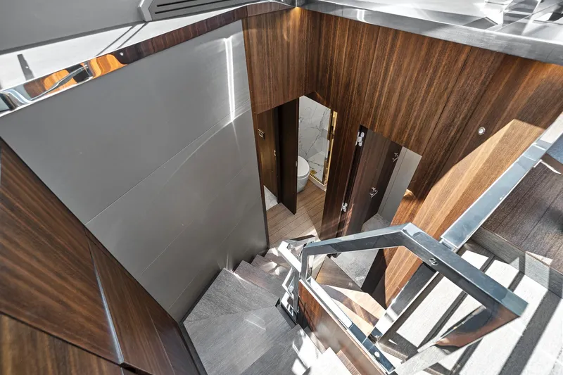 Smile Yacht Photos Pics Staircase interior of 2023 Astondoa 66 Flybridge yacht with modern wood paneling.