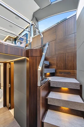 Smile Yacht Photos Pics Luxurious interior staircase of 2023 Astondoa 66 Flybridge yacht with modern wood finish.