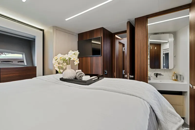 Smile Yacht Photos Pics Luxurious bedroom in 2023 Astondoa 66 Flybridge yacht with modern decor and ensuite bathroom.