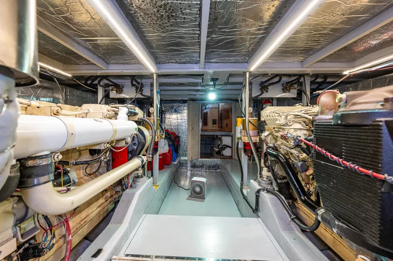 Holiday Yacht Photos Pics Engine room of 1991 Tollycraft 48 Cockpit Motor Yacht, showcasing dual engines and mechanical systems.