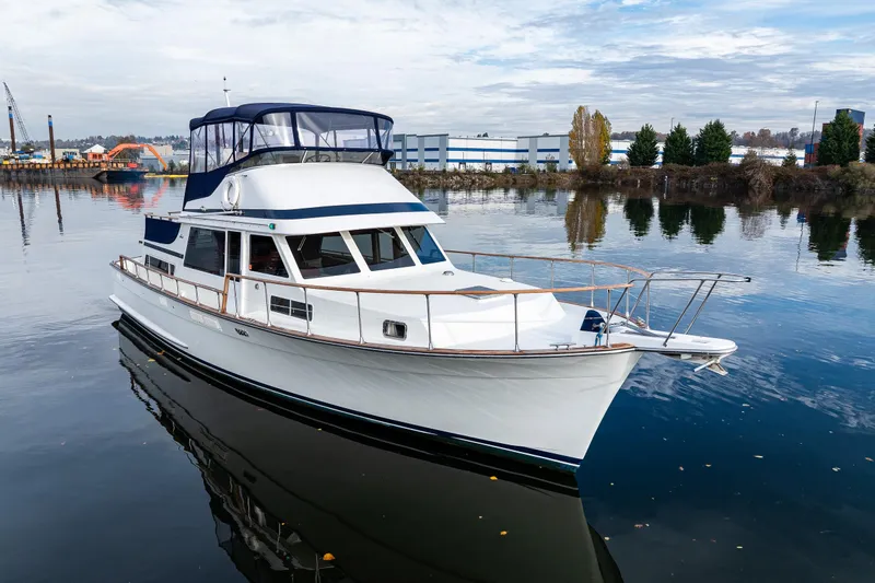 Holiday Yacht Photos Pics 1991 Tollycraft 48 Cockpit Motor Yacht on calm water, showcasing elegant design and spacious deck.
