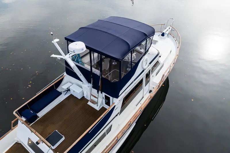 Holiday Yacht Photos Pics 1991 Tollycraft 48 Cockpit Motor Yacht on calm water, featuring a blue canopy.