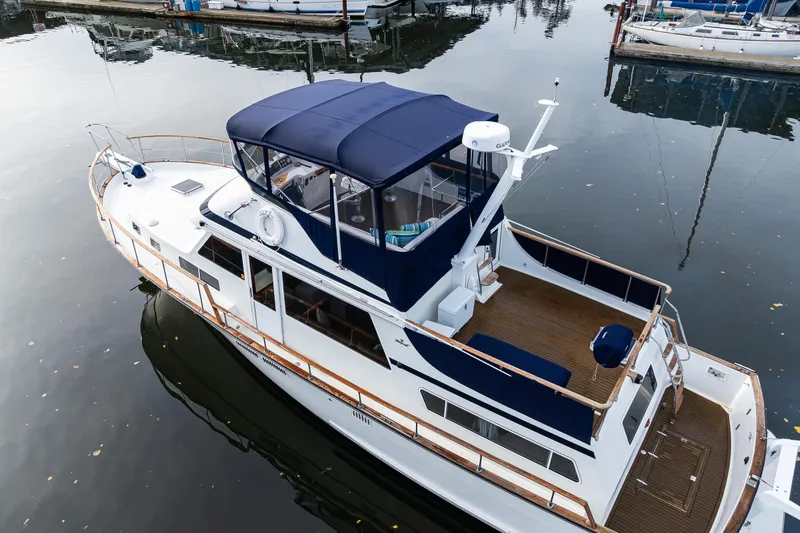 Holiday Yacht Photos Pics 1991 Tollycraft 48 Cockpit Motor Yacht docked in calm marina waters.