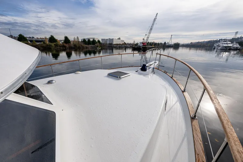 Holiday Yacht Photos Pics 1991 Tollycraft 48 Cockpit Motor Yacht on calm water with scenic background.