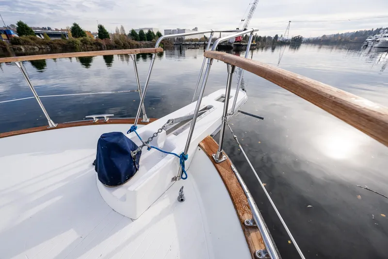 Holiday Yacht Photos Pics 1991 Tollycraft 48 Cockpit Motor Yacht deck with railing, docked on calm water.