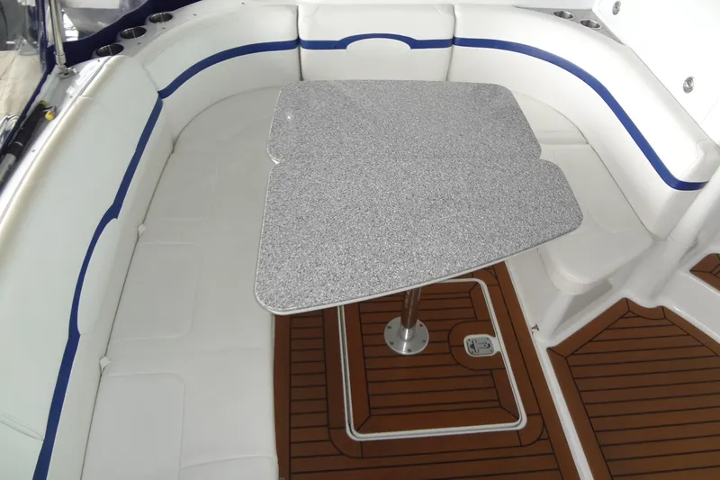 Dream Catcher Yacht Photos Pics 2010 Formula 45 Yacht interior with white seating and a speckled table on teak flooring.