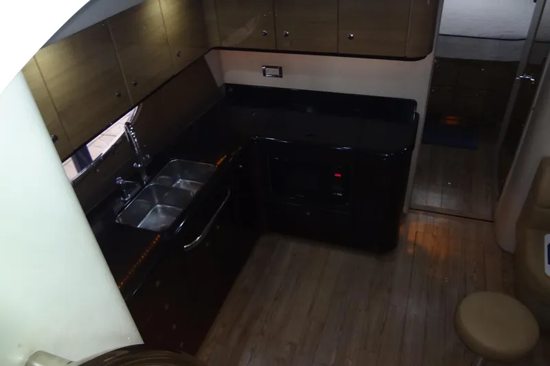 Dream Catcher Yacht Photos Pics Interior of 2010 Formula 45 Yacht kitchen with modern amenities and wooden cabinetry.