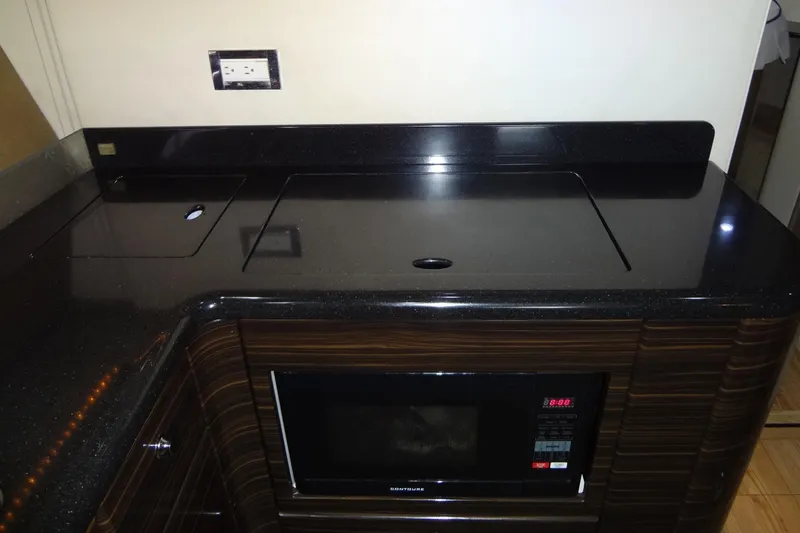 Dream Catcher Yacht Photos Pics Modern kitchen area in a 2010 Formula 45 Yacht with sleek black countertop.