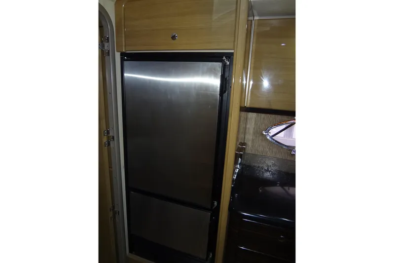 Dream Catcher Yacht Photos Pics Interior of 2010 Formula 45 Yacht featuring stainless steel refrigerator and wooden cabinetry.