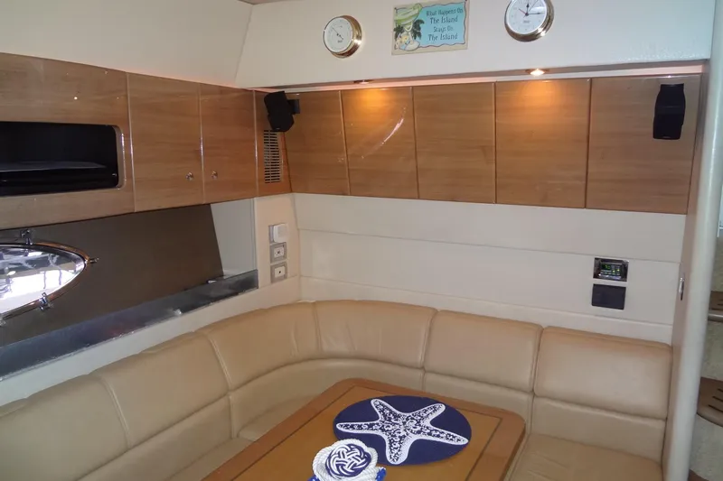Dream Catcher Yacht Photos Pics Luxurious interior of 2010 Formula 45 Yacht with beige seating and wooden cabinets.