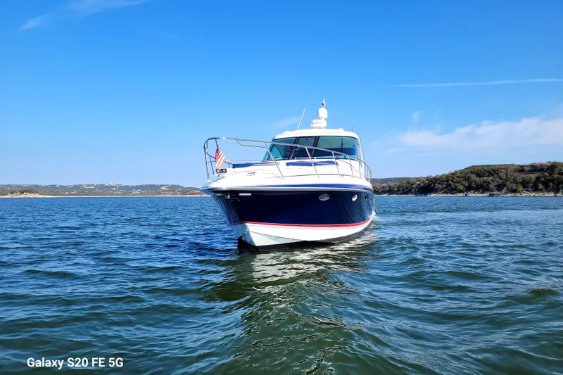 Dream Catcher Yacht Photos Pics 2010 Formula 45 Yacht on serene lake under clear blue sky.
