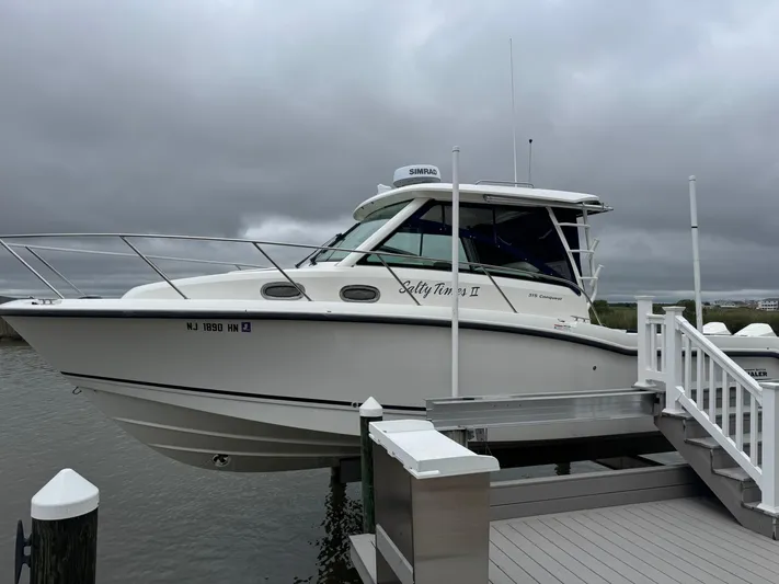  Yacht Photos Pics 2019 Boston Whaler 315 Conquest docked under cloudy skies.