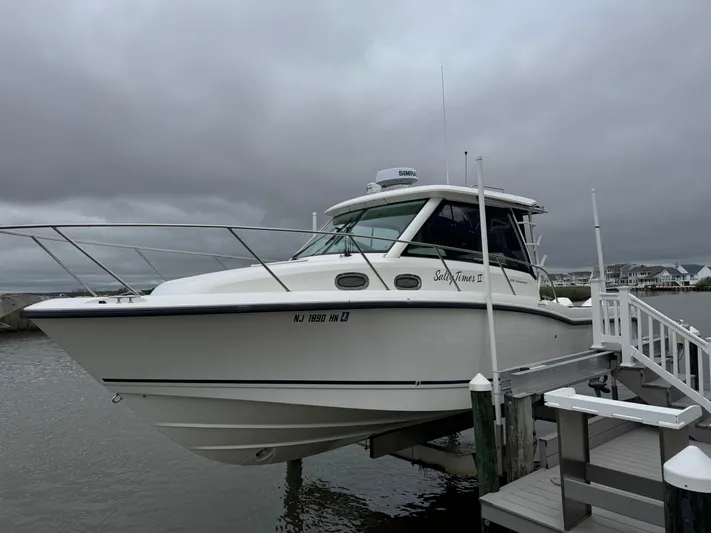  Yacht Photos Pics 2019 Boston Whaler 315 Conquest docked under cloudy skies.