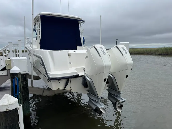  Yacht Photos Pics 2019 Boston Whaler 315 Conquest with twin outboard engines docked by the water.