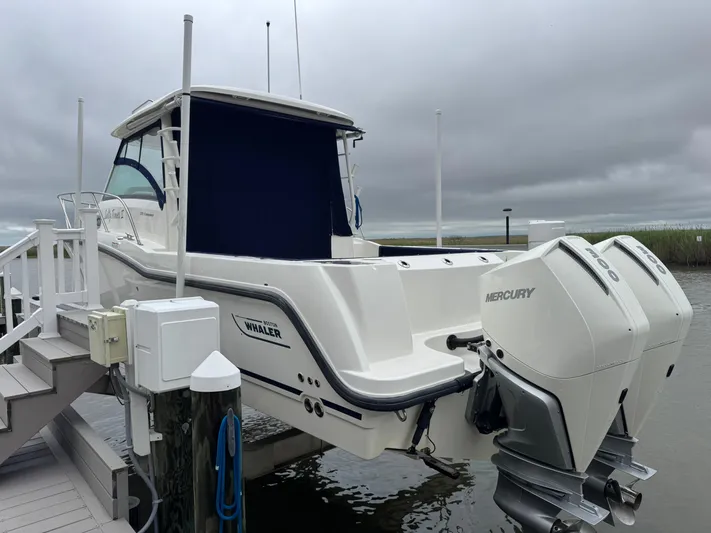  Yacht Photos Pics 2019 Boston Whaler 315 Conquest boat docked, featuring dual Mercury outboard engines.