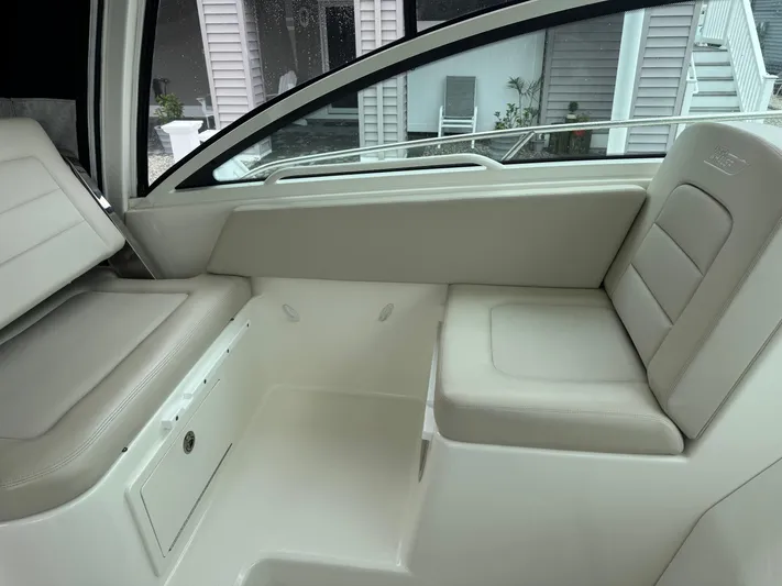  Yacht Photos Pics Interior seating of a 2019 Boston Whaler 315 Conquest boat, featuring beige upholstery.
