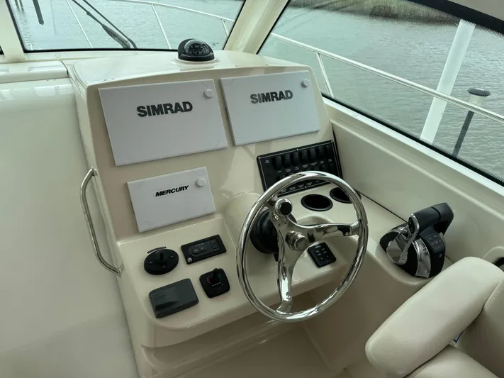  Yacht Photos Pics 2019 Boston Whaler 315 Conquest helm with Simrad displays and Mercury controls.
