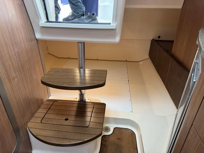  Yacht Photos Pics 2019 Boston Whaler 315 Conquest interior with wooden steps and modern design.