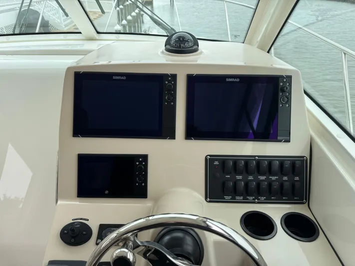  Yacht Photos Pics Helm of 2019 Boston Whaler 315 Conquest with navigation screens and controls.