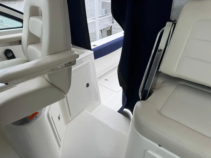  Yacht Photos Pics 2019 Boston Whaler 315 Conquest interior with white seating and blue accents.