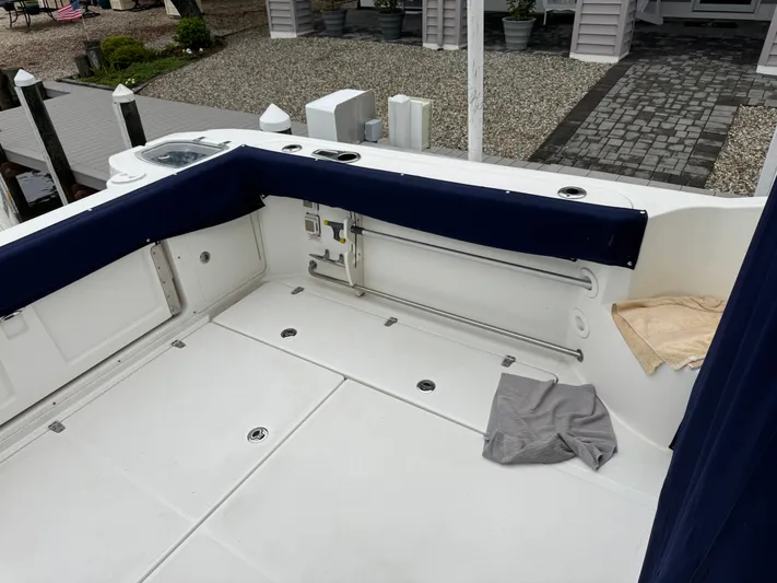  Yacht Photos Pics 2019 Boston Whaler 315 Conquest boat deck with blue seating and storage compartments.