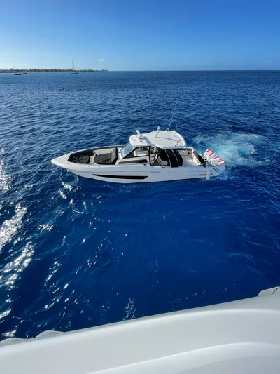 Bft Yacht Photos Pics 2021 Boston Whaler 420OR boat cruising on clear blue ocean waters.