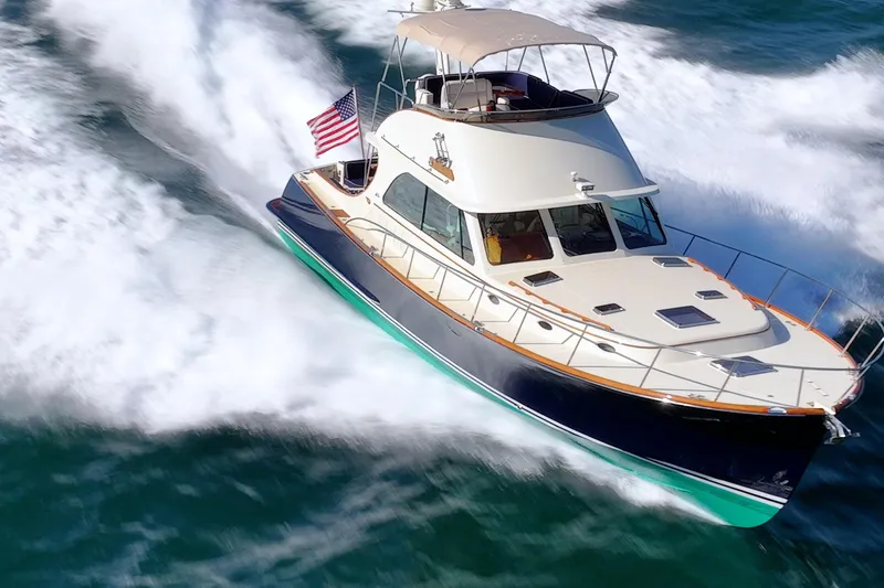 Virginia Yacht Photos Pics 2013 Hinckley Talaria 48 Flybridge yacht cruising on open water, American flag displayed.