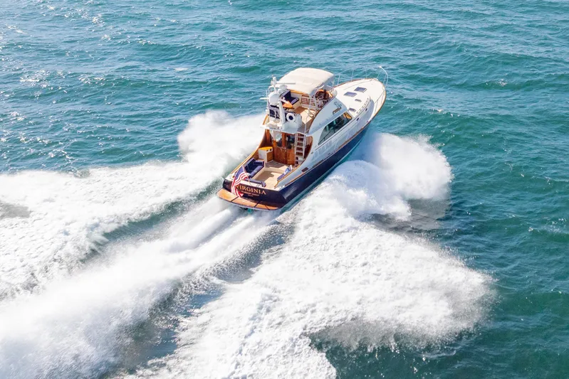 Virginia Yacht Photos Pics 2013 Hinckley Talaria 48 Flybridge cruising on open water, creating a dynamic wake.