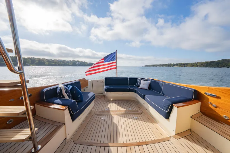 Virginia Yacht Photos Pics 2013 Hinckley Talaria 48 Flybridge yacht with elegant seating and American flag on open water.