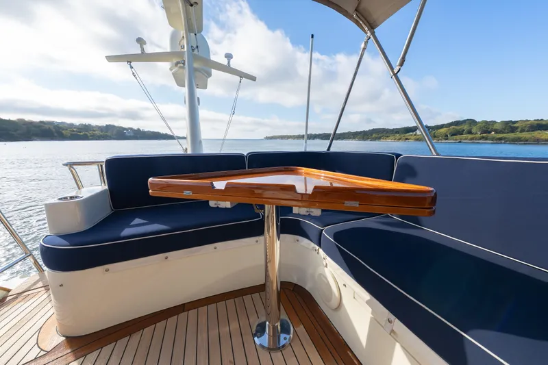 Virginia Yacht Photos Pics 2013 Hinckley Talaria 48 Flybridge with elegant seating and wooden table on deck.