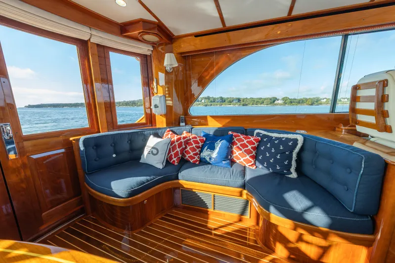 Virginia Yacht Photos Pics Luxurious interior of 2013 Hinckley Talaria 48 Flybridge with plush seating and nautical decor.
