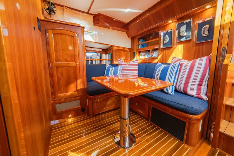 Virginia Yacht Photos Pics Luxurious 2013 Hinckley Talaria 48 Flybridge interior with wood finish and striped cushions.