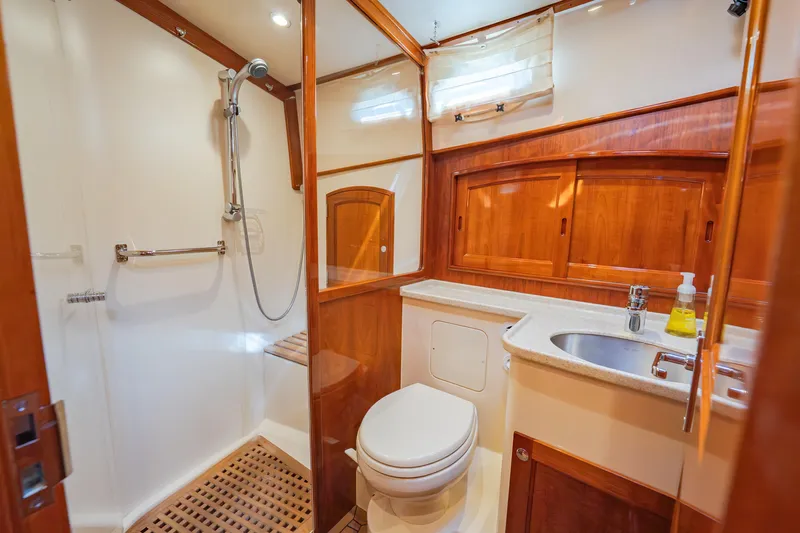 Virginia Yacht Photos Pics Luxurious bathroom in 2013 Hinckley Talaria 48 Flybridge yacht with wood accents and modern fixtures.