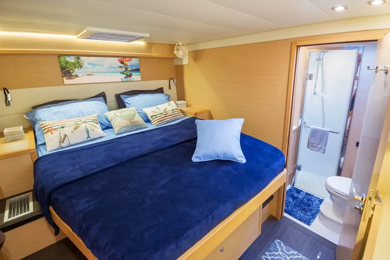 Sami Malu Yacht Photos Pics Luxurious cabin interior of 2017 Lagoon 52 F yacht with cozy bed and ensuite bathroom.
