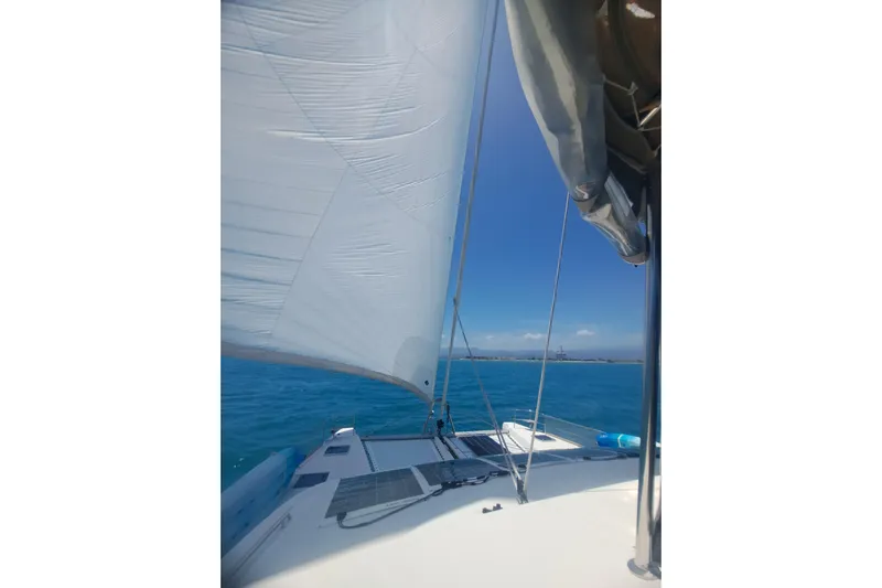 Sami Malu Yacht Photos Pics Sailing on a 2017 Lagoon 52 F catamaran in clear blue waters.