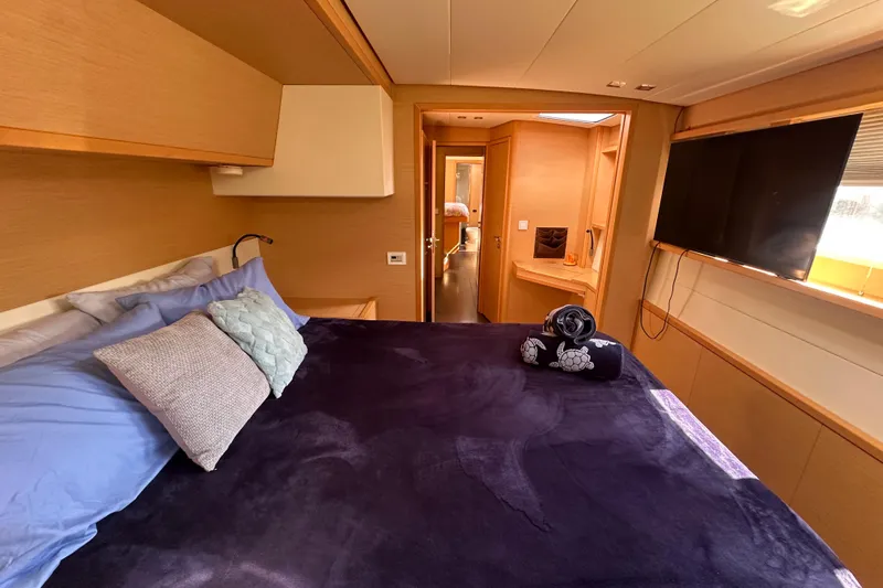 Sami Malu Yacht Photos Pics Luxurious cabin interior of 2017 Lagoon 52 F yacht with cozy bedding and modern amenities.